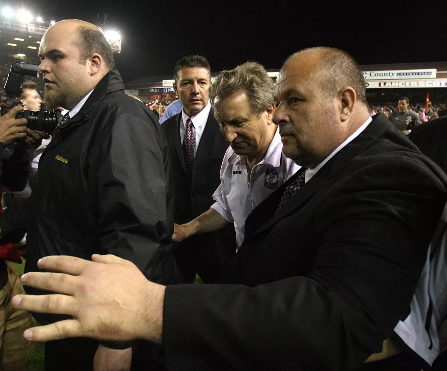 Neil Warnock escorted off the pitch at Ashton Gate. Image: Alamy
