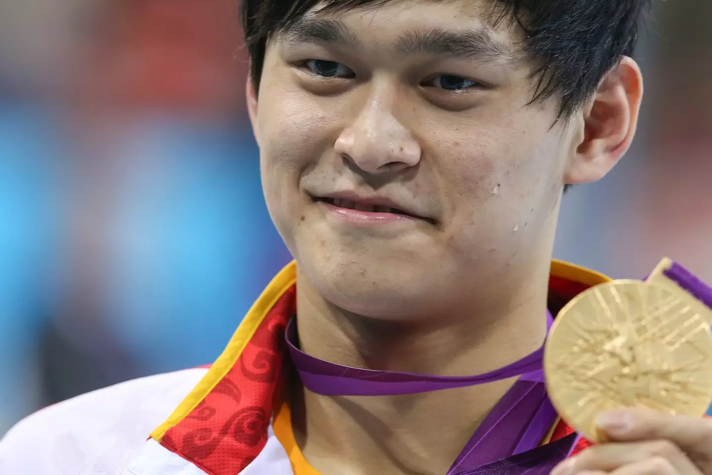 Sun Yang poses with his gold medal after winning the 1500m freestyle finals at London 2012. Image credit: Getty