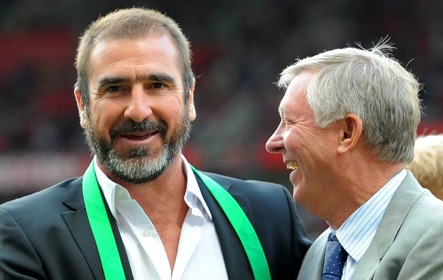 Eric Cantona shares a warm embrace with Sir Alex Ferguson. Image: Getty