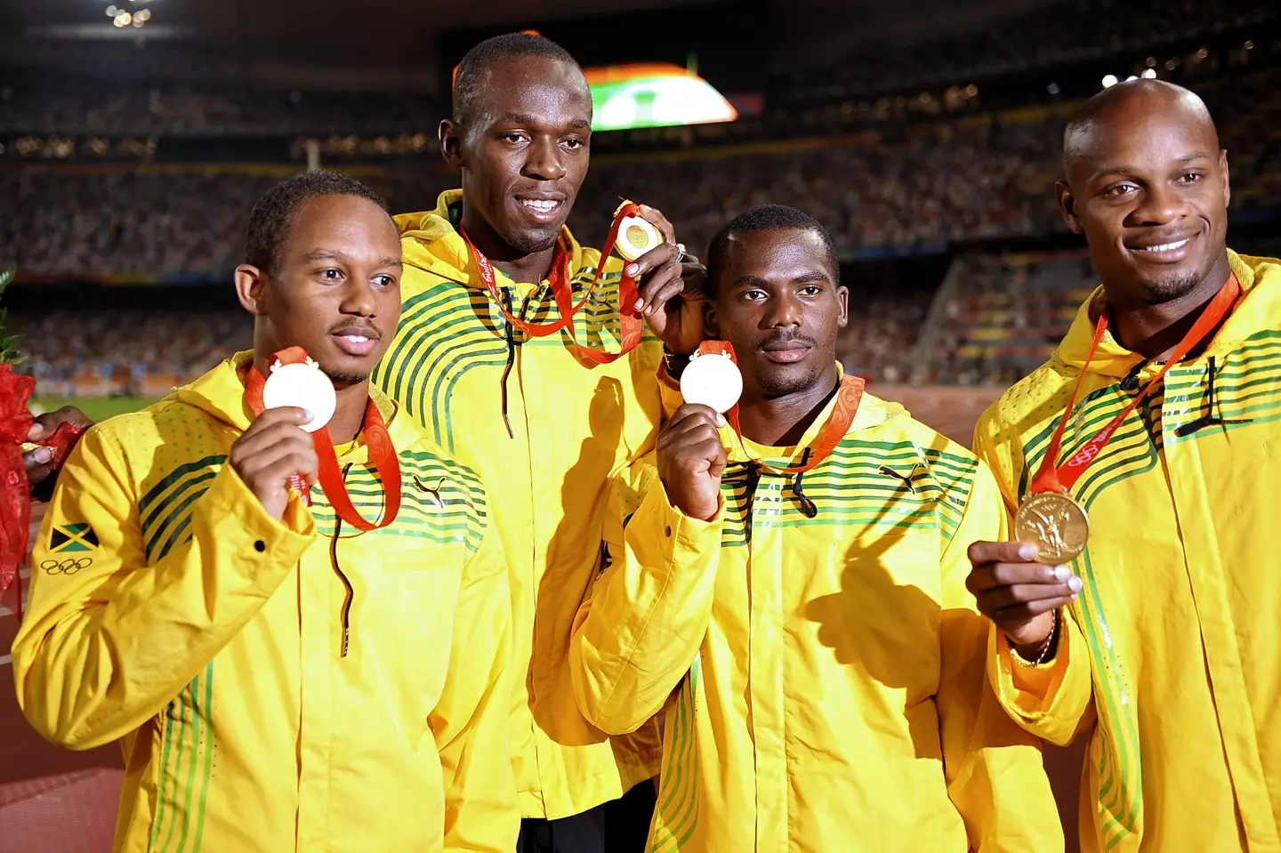 Bolt and his teammates collect their medals. Image: Alamy