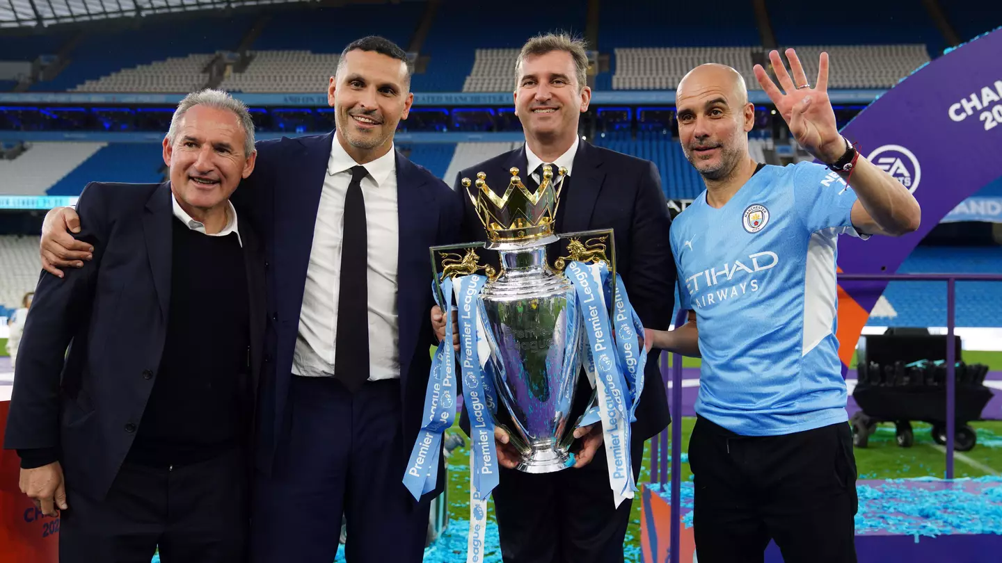 Manchester City officials and Pep Guardiola with the 2022 Premier League trophy (Alamy)