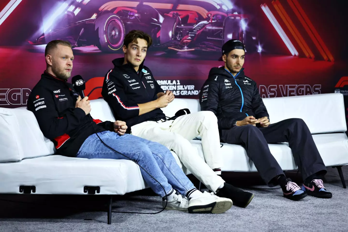 George Russell (centre), Kevin Magnussen (left) and Esteban Ocon (right) during the Las Vegas GP press conference (Image: Getty)