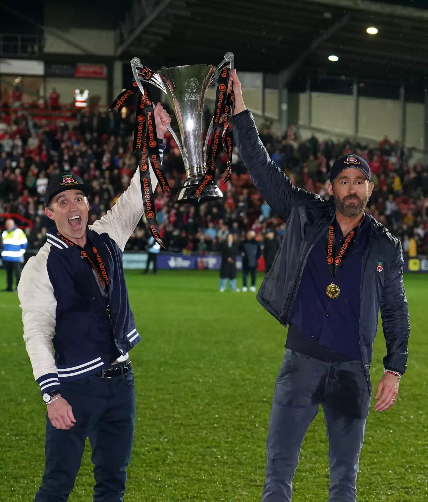 Wrexham owners Ryan Reynolds and Rob McElhenney lifting the National League title. (