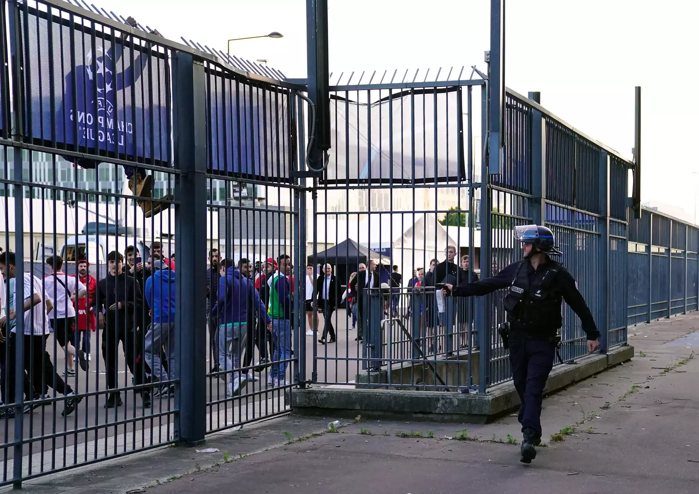 A police officer using pepper spray outside the stadium. (Image