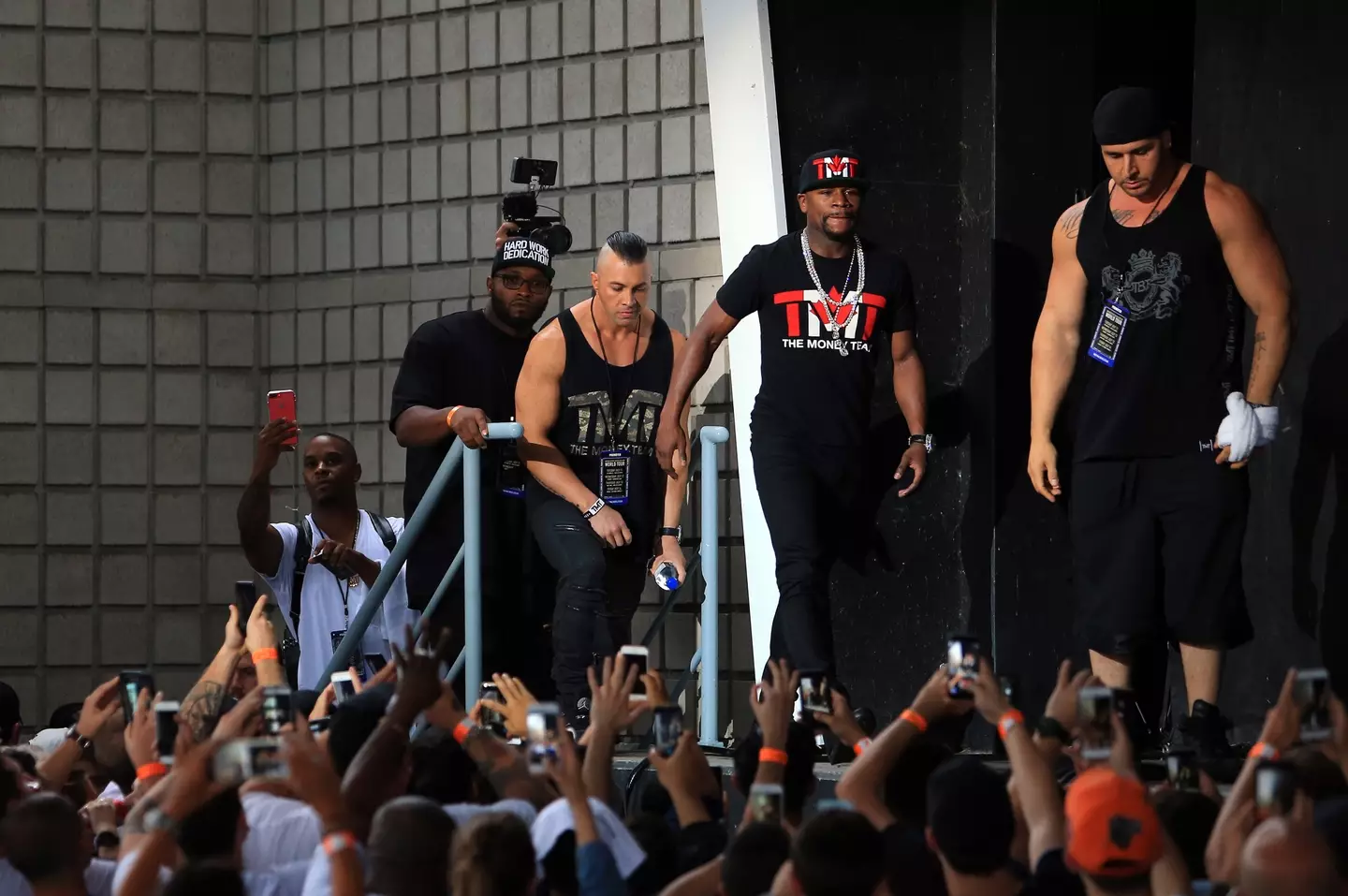 Floyd Mayweather joined by his bodyguards for a press conference with Conor McGregor. Image: Getty