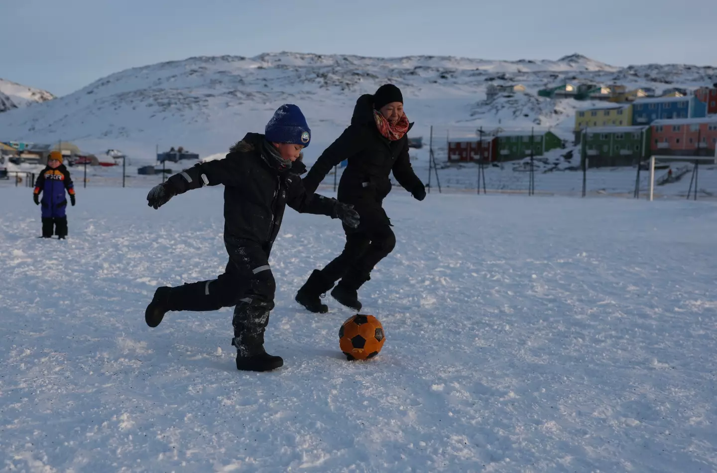 Members of the public play football in arctic conditions in Greenland. Image: Getty