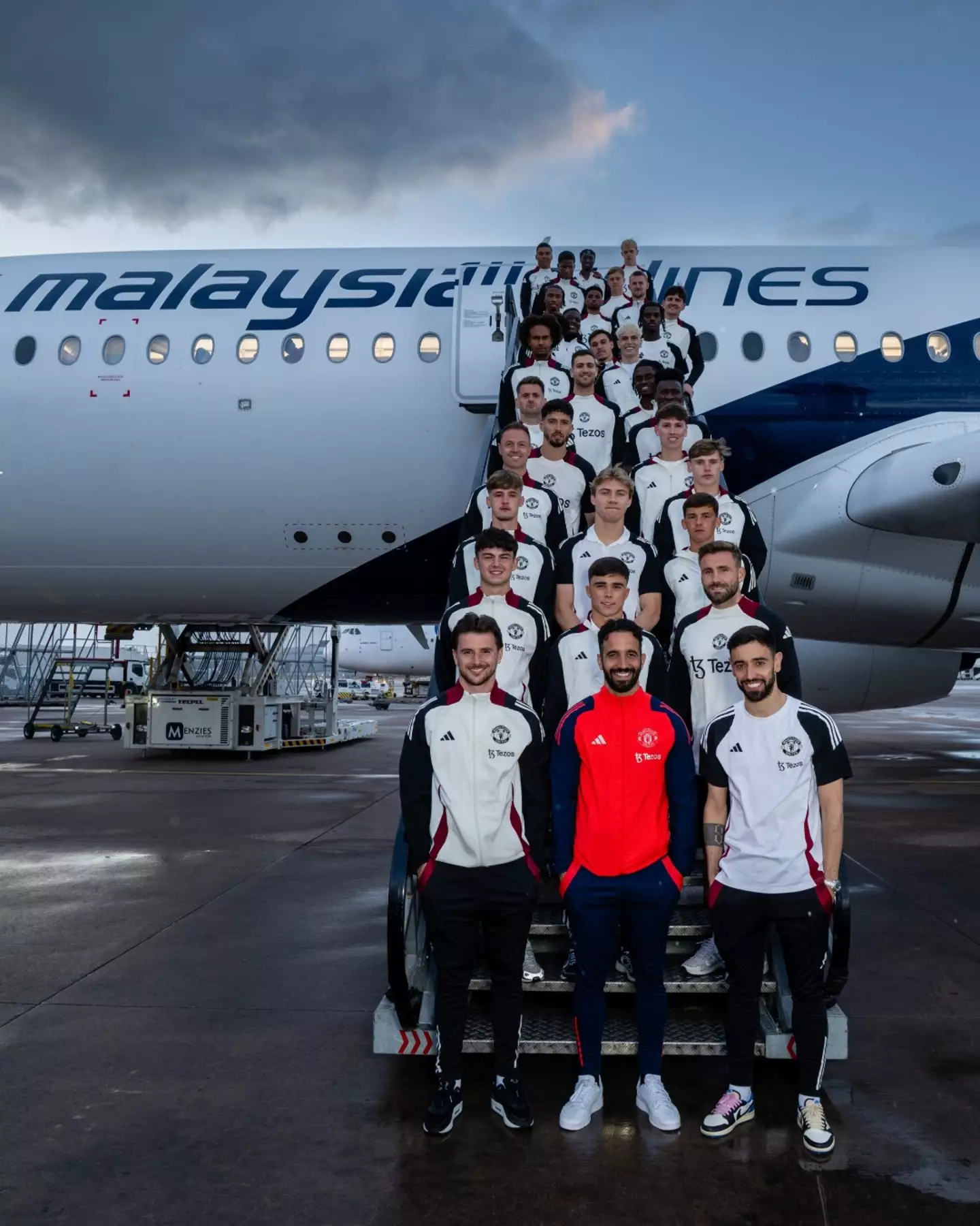 Ruben Amorim and his United squad ahead of their flight to Asia. Image credit: Manchester United/X