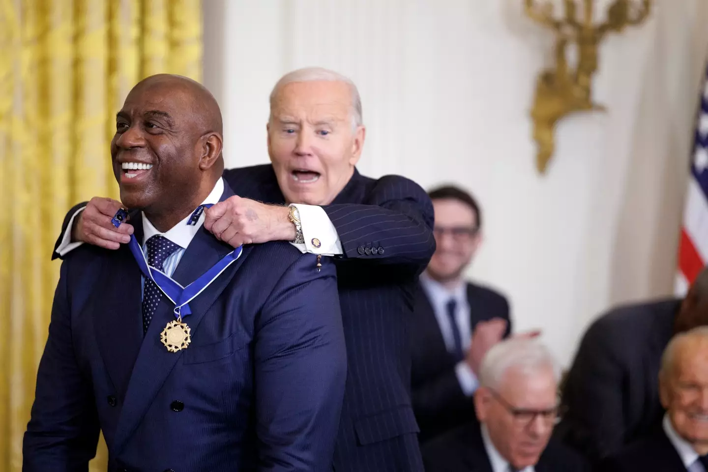 NBA legend Magic Johnson receives his medal from Joe Biden. Image: Getty