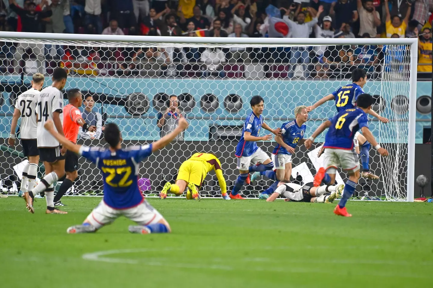 The Japan team celebrate scoring against Germany. Image: Alamy