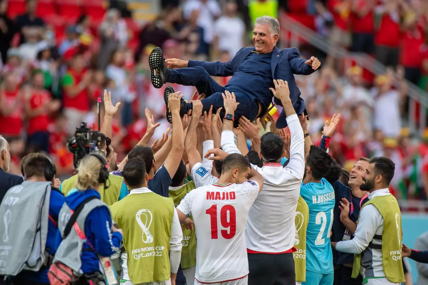 Carlos Queiroz raised in the air by the Iran following their win over Wales. Image: Alamy