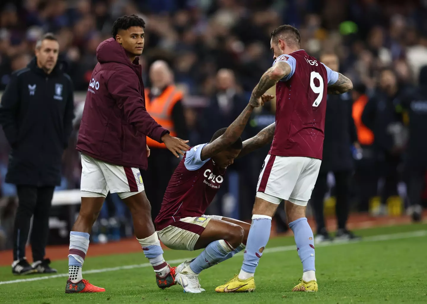 Bailey being helped to his feet by Ings and Watkins. (Image
