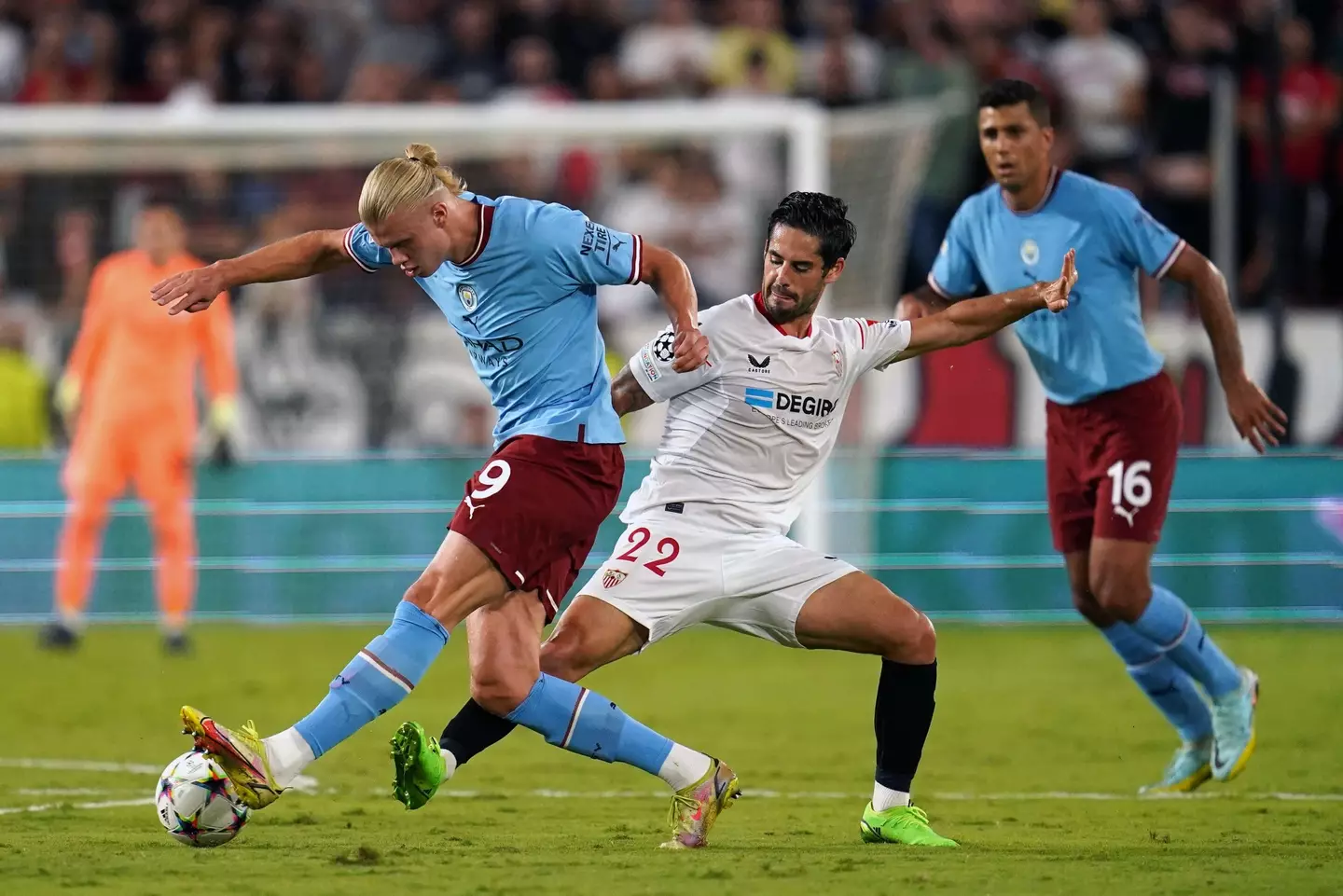 Erling Haaland battles with Isco. (Image