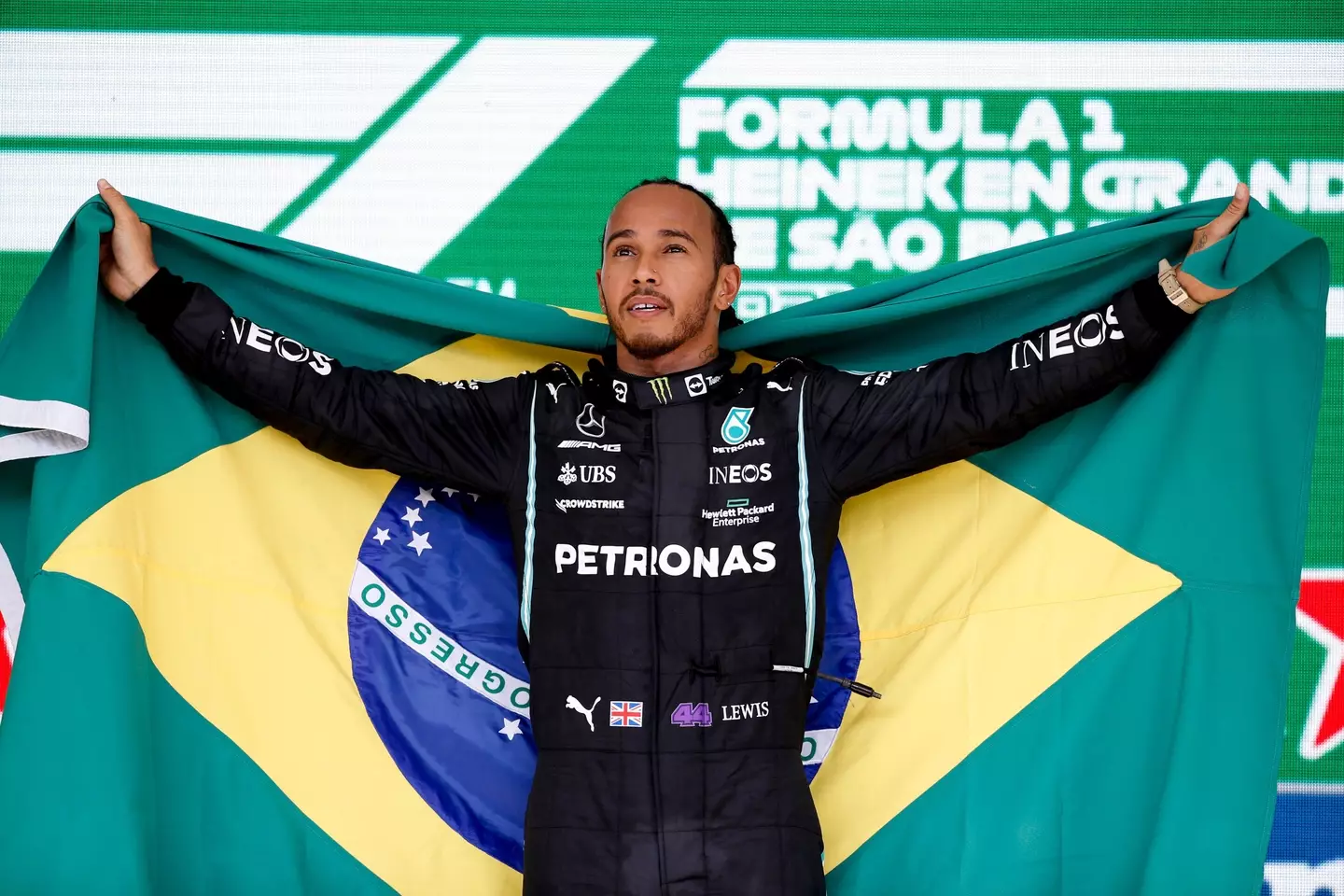 Hamilton celebrates with the Brazilian flag. Image: PA Images
