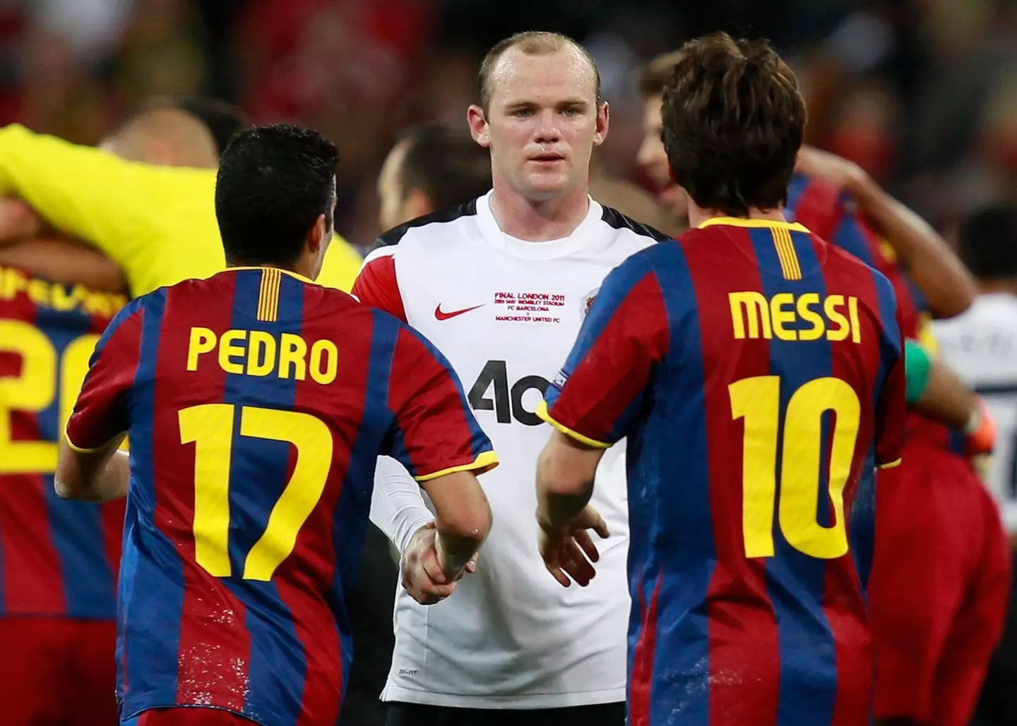 Rooney looks at Pedro and Messi during the game. (Image