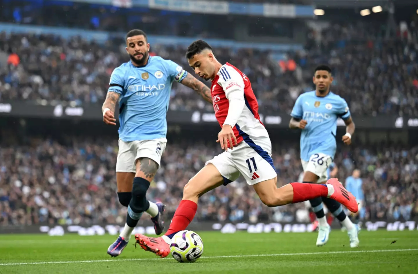 Kyle Walker battles for the ball with Arsenal's Gabriel Martinelli -