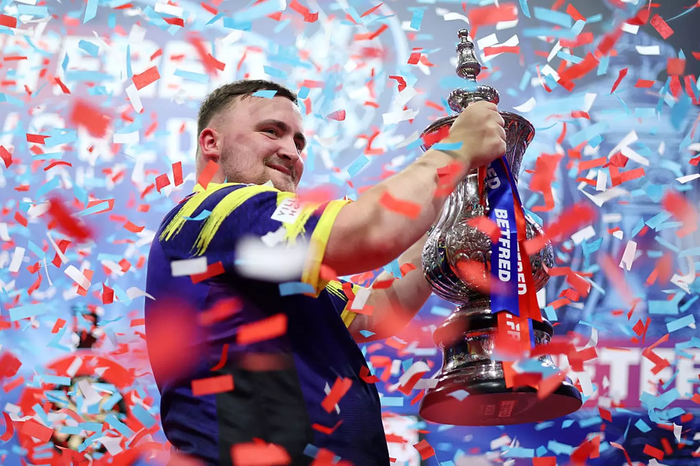 Luke Littler is now the youngest person to win the Matchplay Darts final. (Image: Getty)