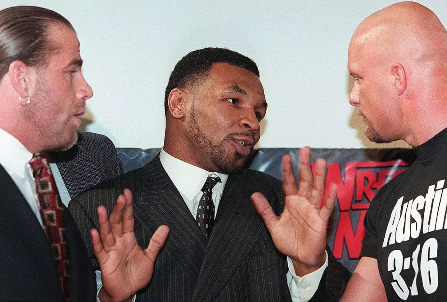 Mike Tyson pictured with Shawn Michaels (left) and 'Stone Cold' Steve Austin (right) before WrestleMania 14 (