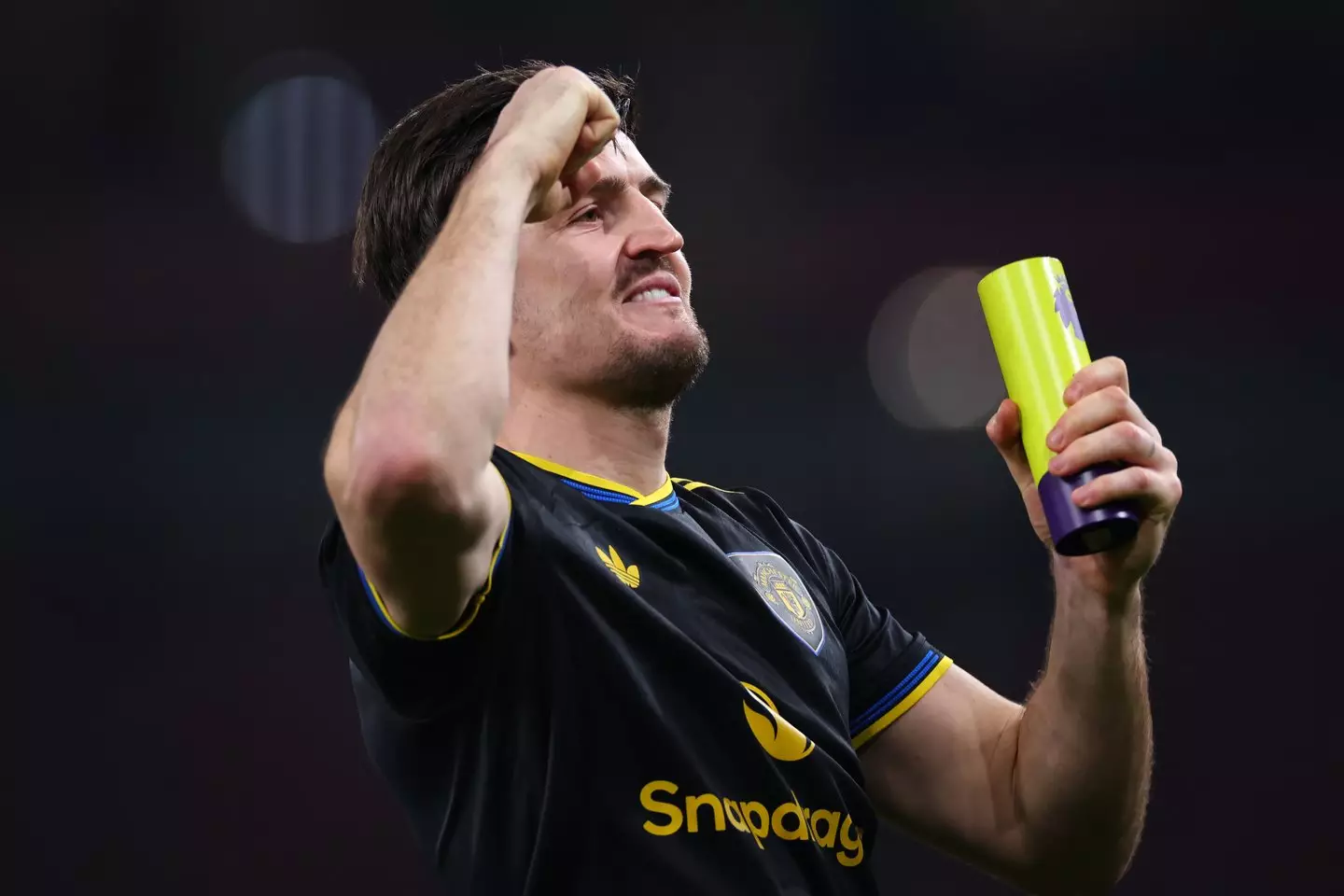 Harry Maguire celebrates Manchester United's victory over Arsenal with the Man of the Match award in his hand. Image: Getty