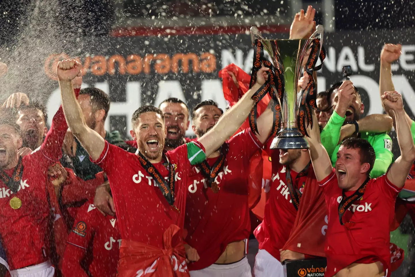 Wrexham players celebrate winning the 2022/23 National League title (