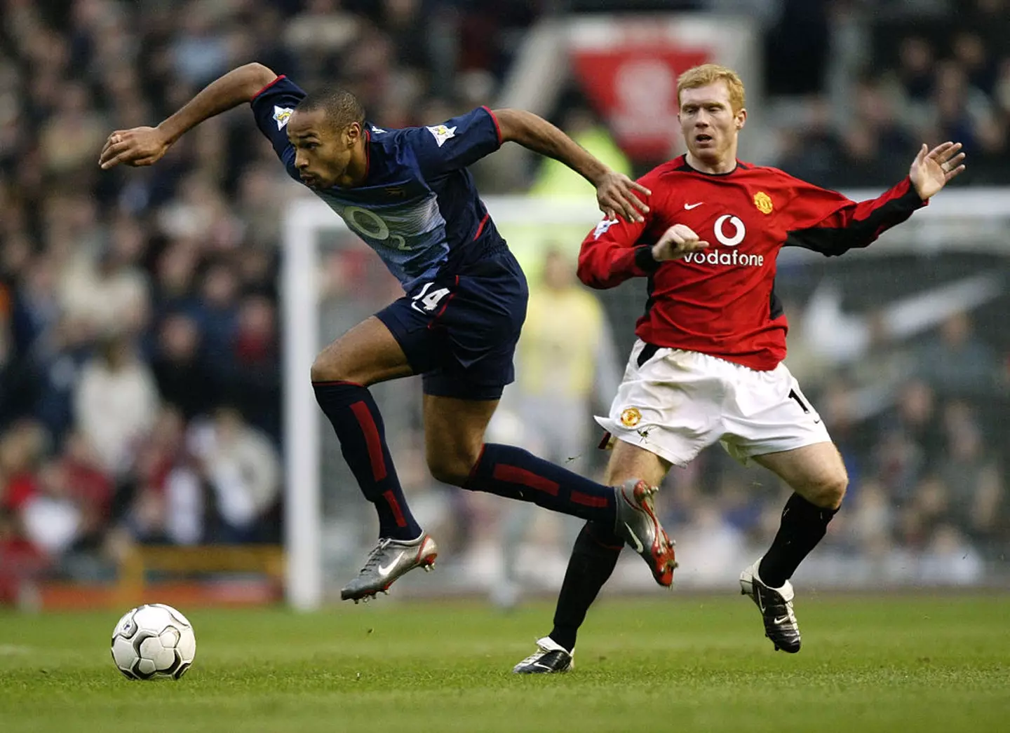 Thierry Henry and Paul Scholes battle for the ball during a game between Man Utd and Arsenal in 2002 (