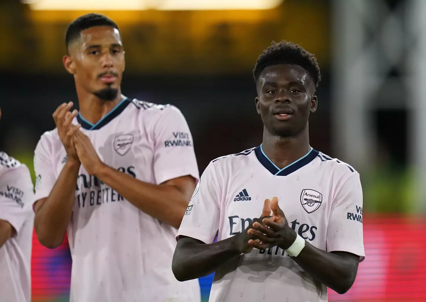 William Saliba and Bukayo Saka clap the Arsenal fans.