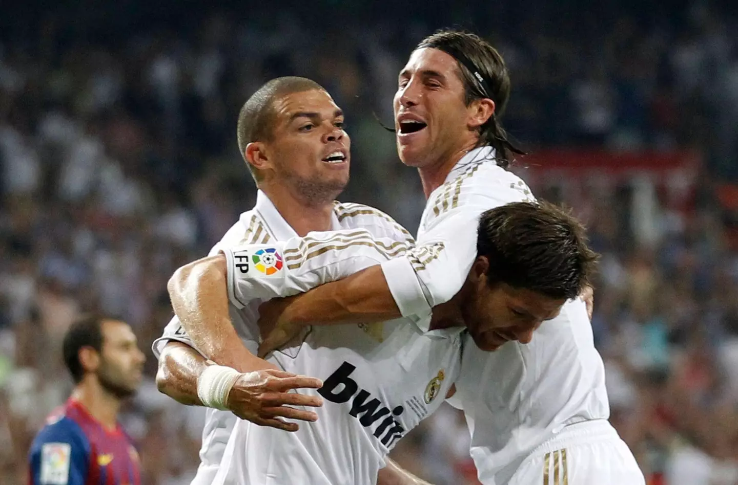Sergio Ramos grabs Xabi Alonso while celebrating with Pepe. (Image
