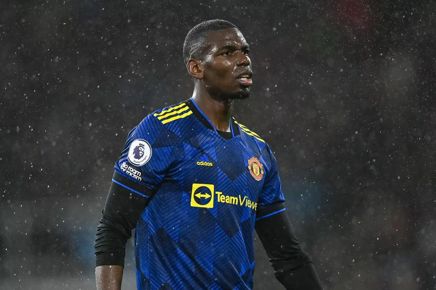 Paul Pogba playing for Manchester United in the rain |