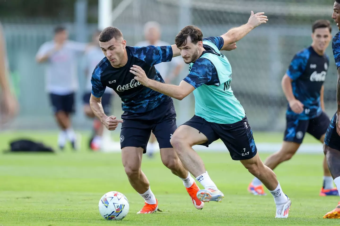 Alessandro Buongiorno and Khvicha Kvaratskhelia battle for the ball during Napoli training - Getty