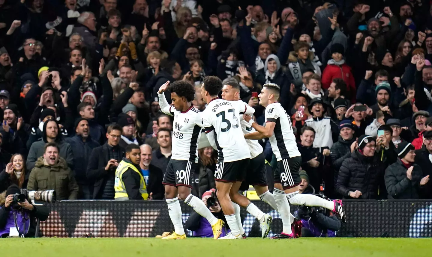Willian was mobbed by his teammates but refused to celebrate. Image: Alamy