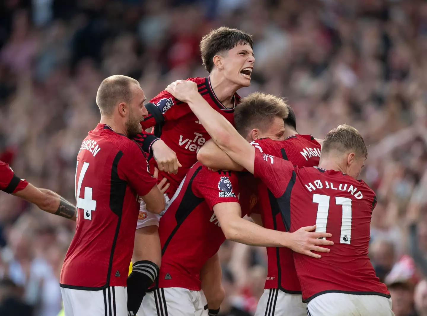 Manchester United players pile on Scott McTominay following his 97th minute winner. (