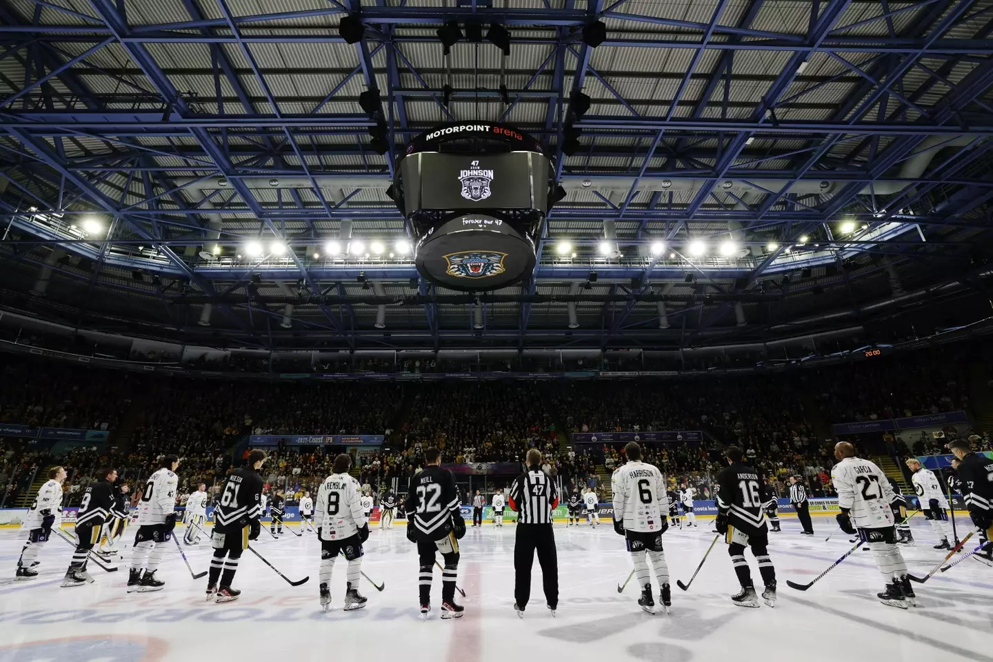 Players and officials observe a moment of silence in remembrance of the late Adam Johnson. Image: Getty