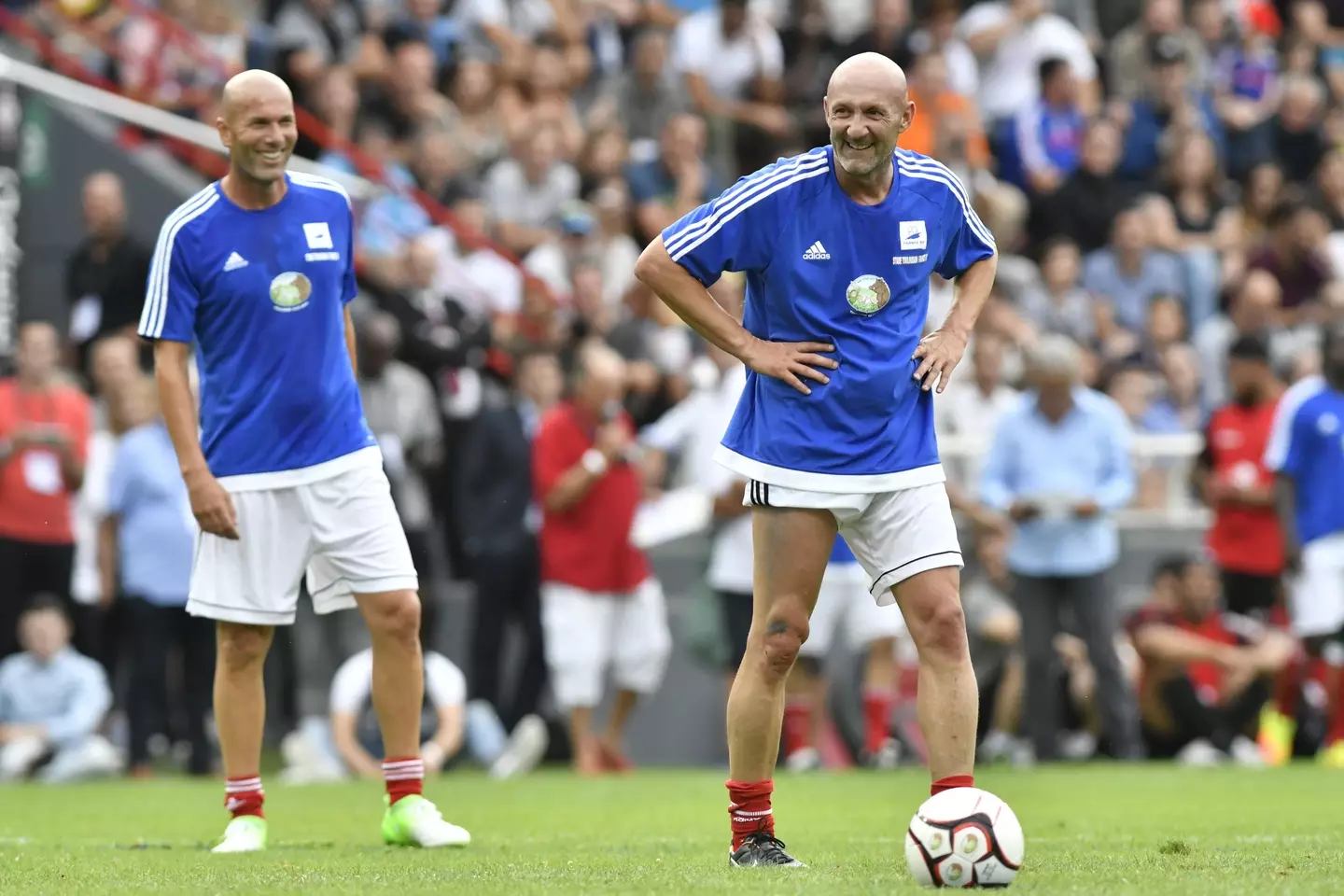 Fabien Barthez and Zinedine Zidane playing football
