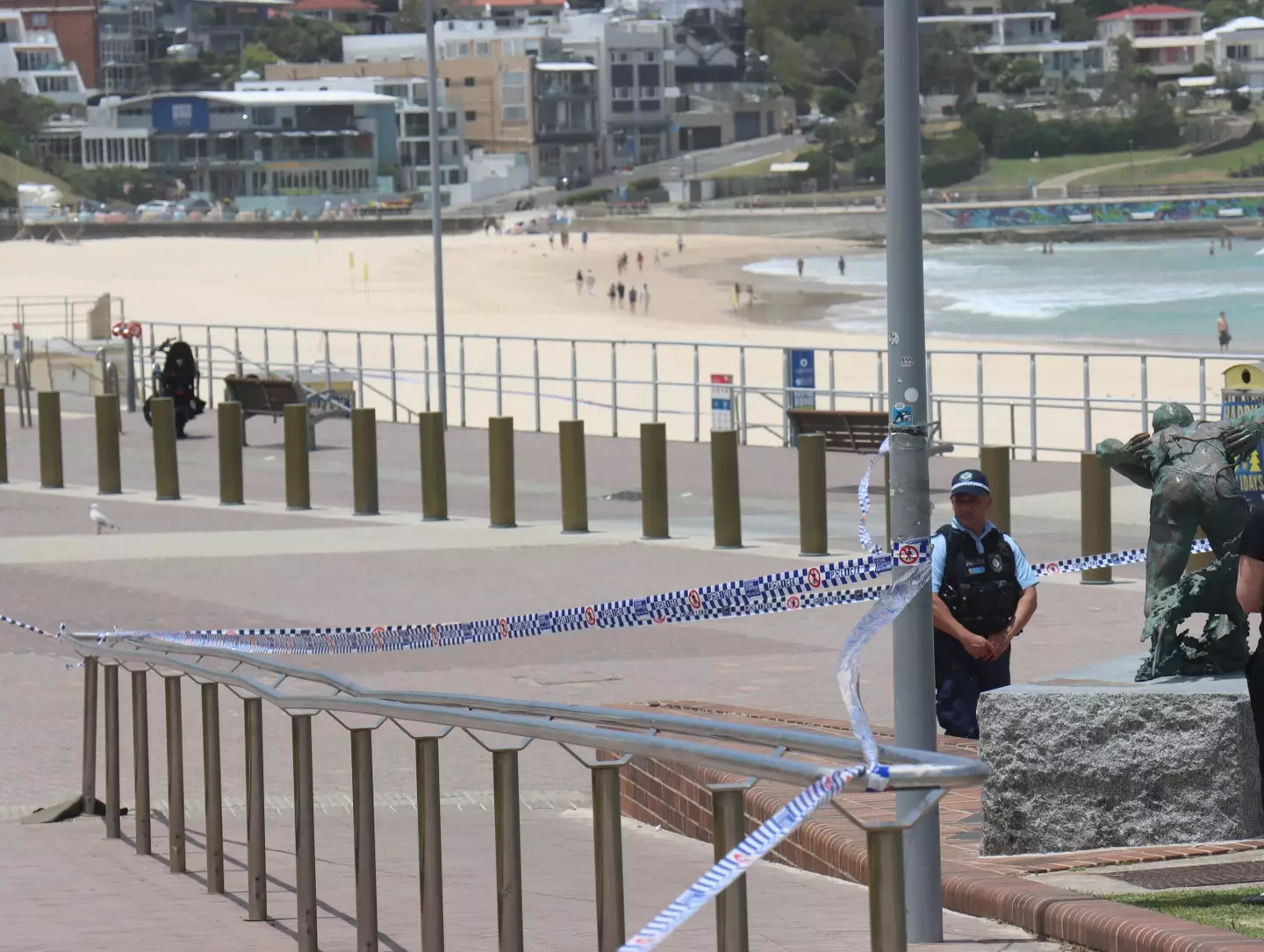 Police set up a cordon line at the scene of the mass shooting at Bondi Beach. Image credit: Getty