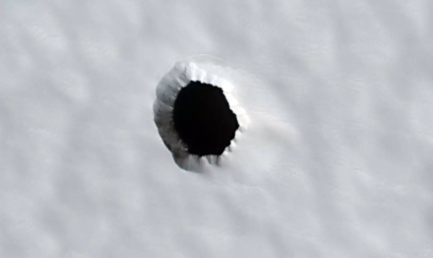 The holes on Mars could be the answer to extraterrestrial life (NASA/JPL-Caltech/UArizona)