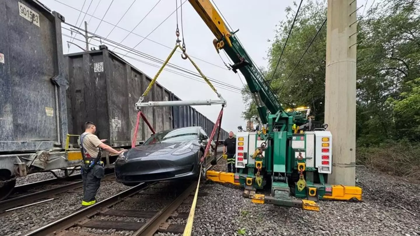 The Tesla being lifted off the train tracks (WFMZ/Spitlers Garage & Towing)