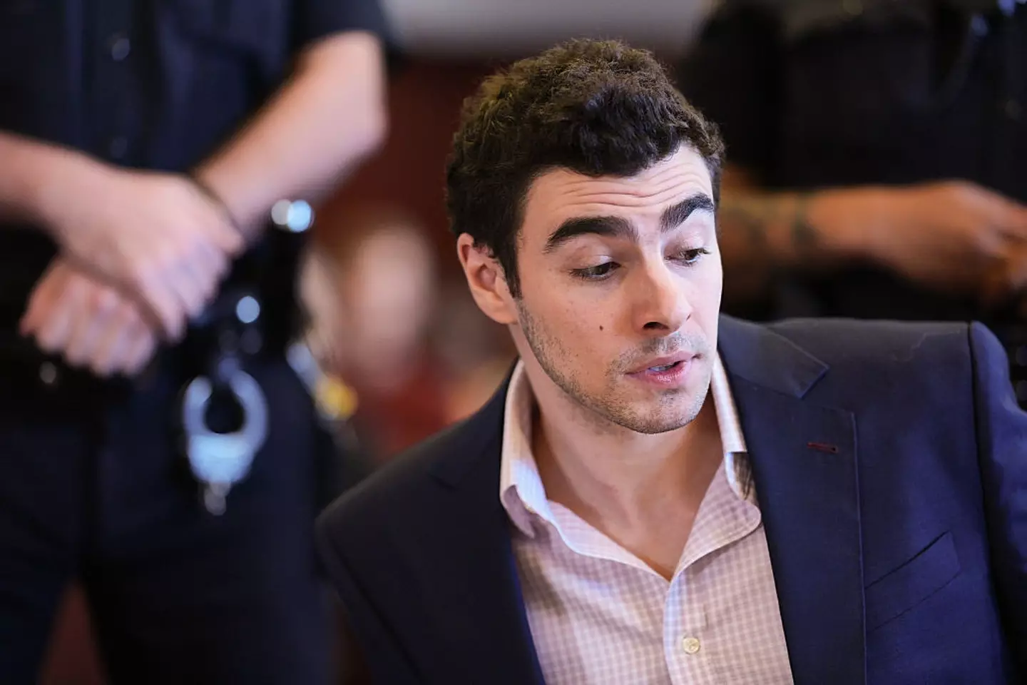 Police were alerted to Mangione's location after someone called, noting that he 'looked suspicious' (Curtis Means-Pool/Getty Images)