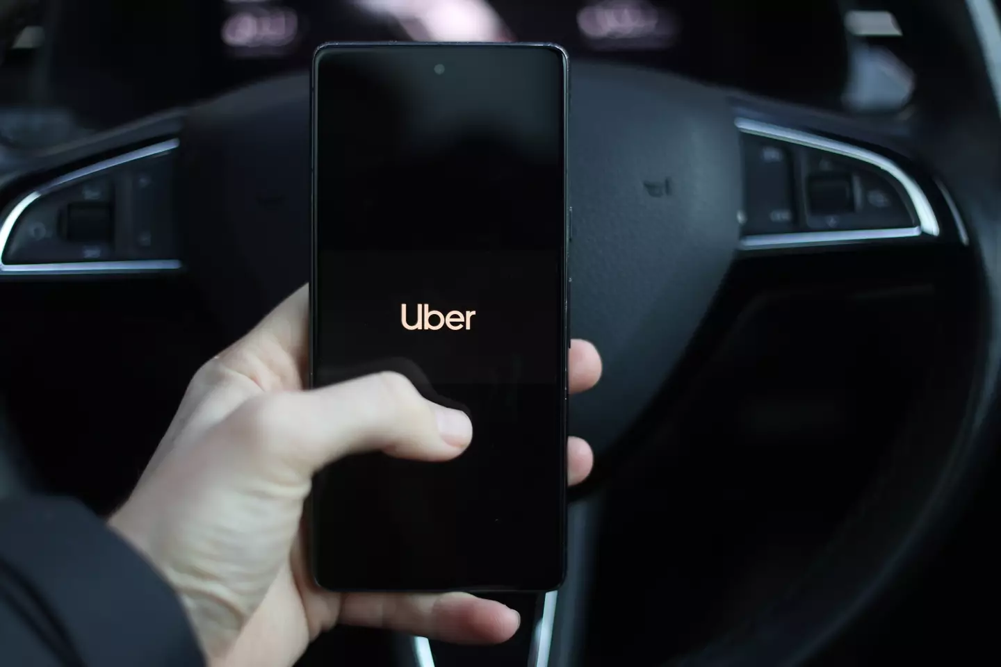 Using the Uber ridesharing app (Getty Images)