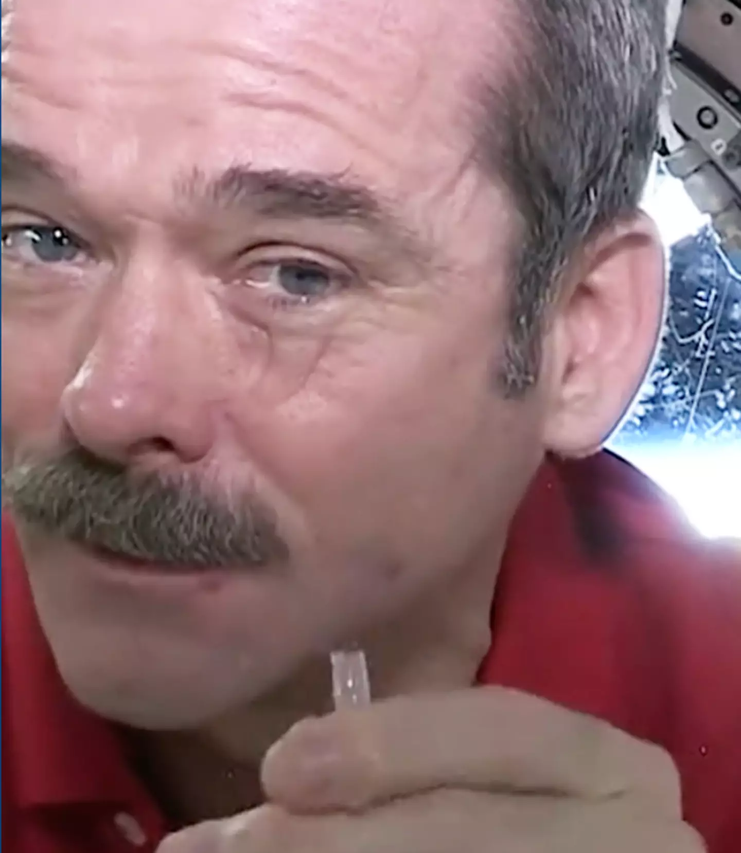 Chris Hadfield shows that tears build up as a ball on your eye but don't fall / CSA