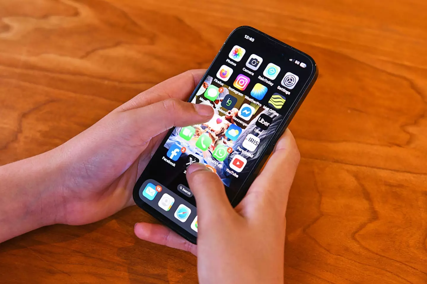 An iPhone being held by a teenager (Getty Images)