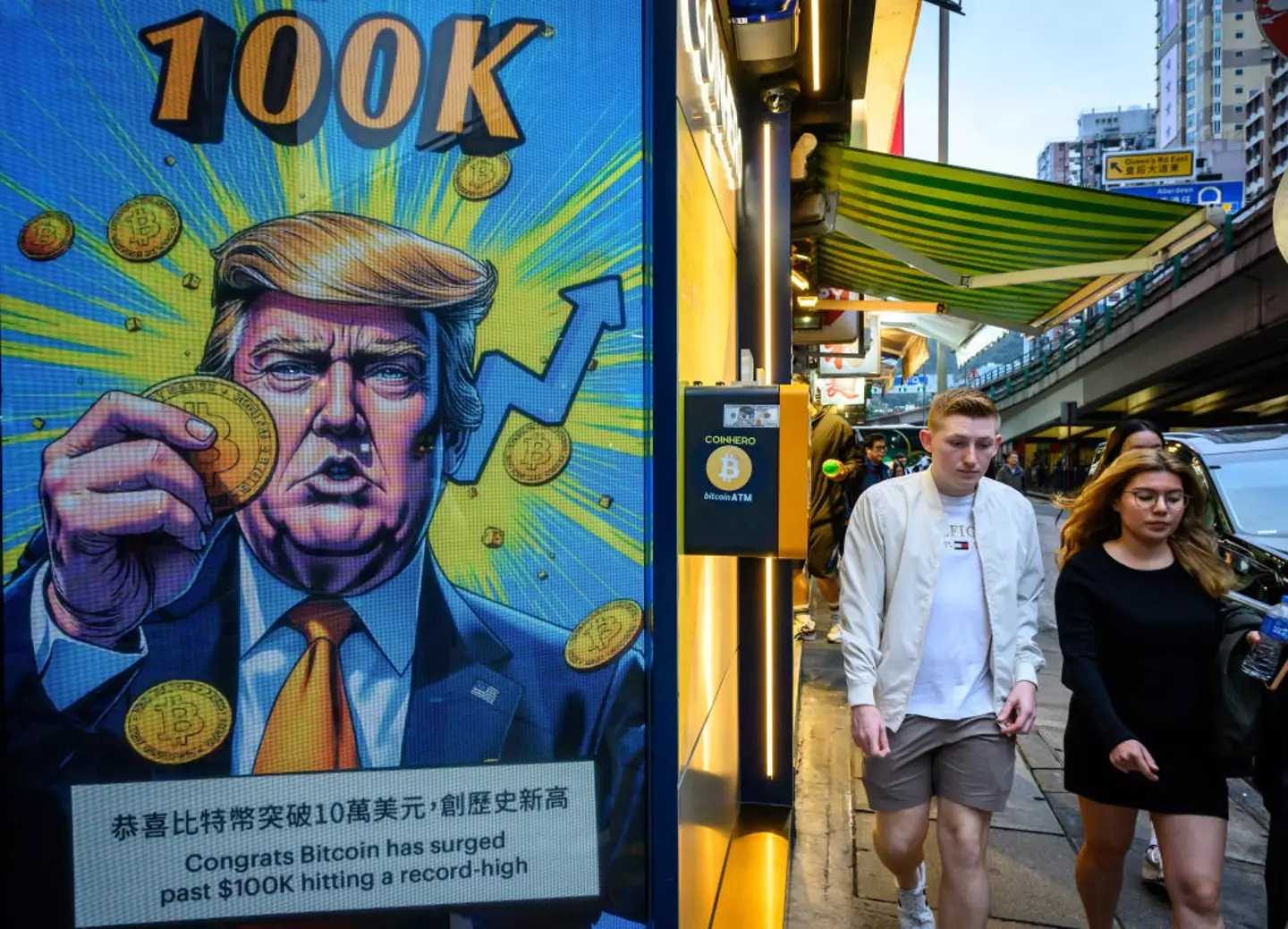 A screen of President Donald Trump holding cryptocurrency coins in Hong Kong (ANTONOV/AFP/Getty Images)