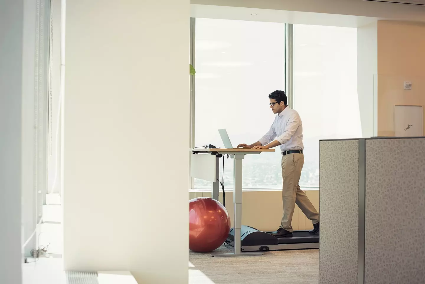 Getting a treadmill underneath a standing desk will make a world of a difference compared to being sat down all day (Getty Stock)