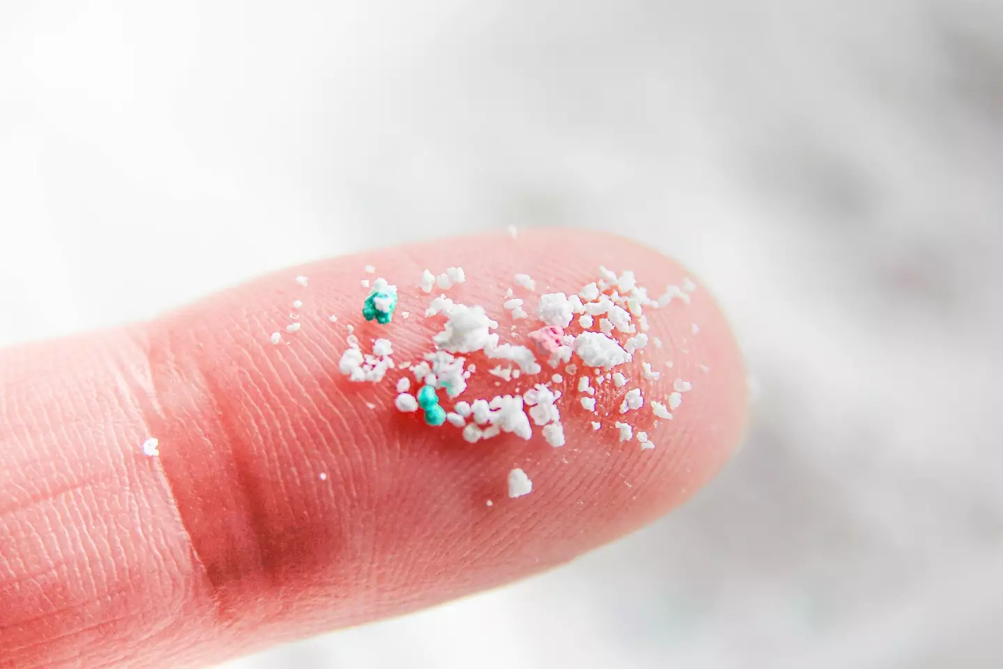A close-up of microplastics on a finger (Getty Images)