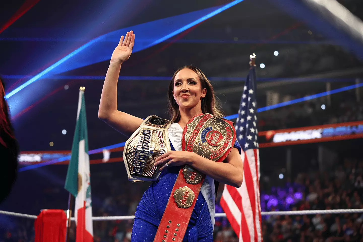 Chelsea Green with WWE and AAA Championships, WWE (via Getty Images)