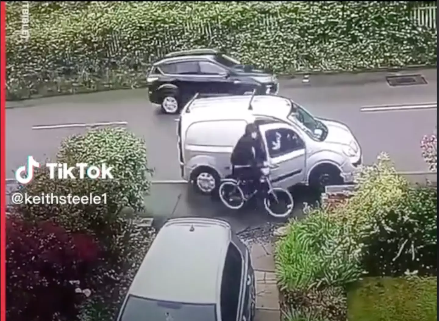 The cyclist cracks into the van driver's car door.