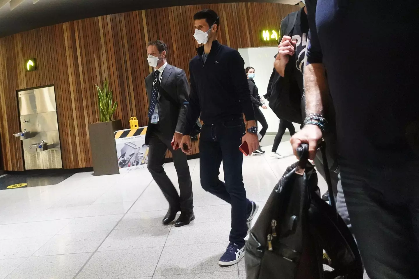Serbian tennis player Novak Djokovic walks in Melbourne Airport before boarding a flight, after the Federal Court upheld a government decision to cancel his visa to play in the Australian Open, in Melbourne.