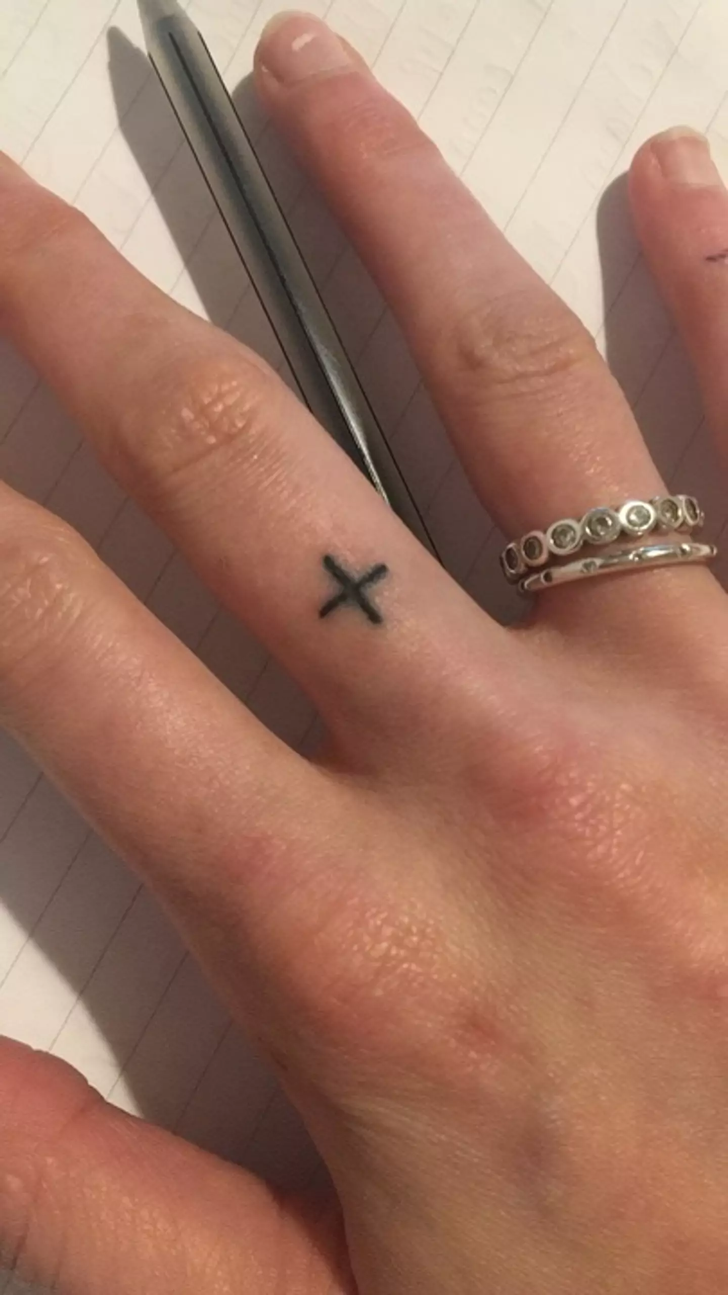 She got a positive sign tattooed on her middle finger in retaliation (Ellie Harrison/Supplied)