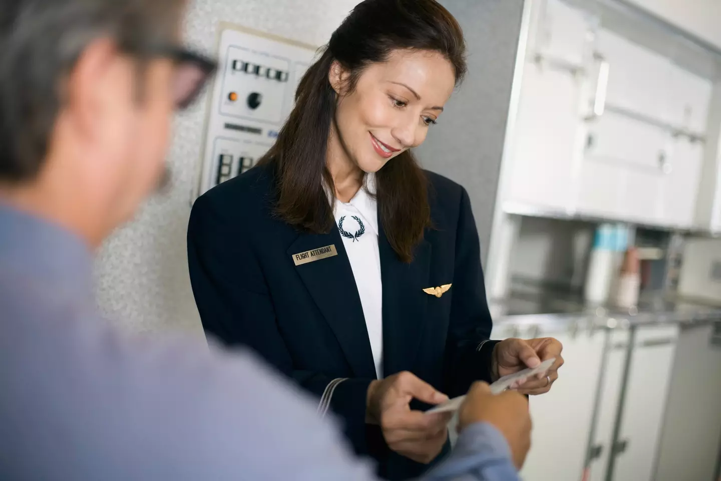 There's many reasons why flight attendants greet you on a plane (Getty Stock Images)