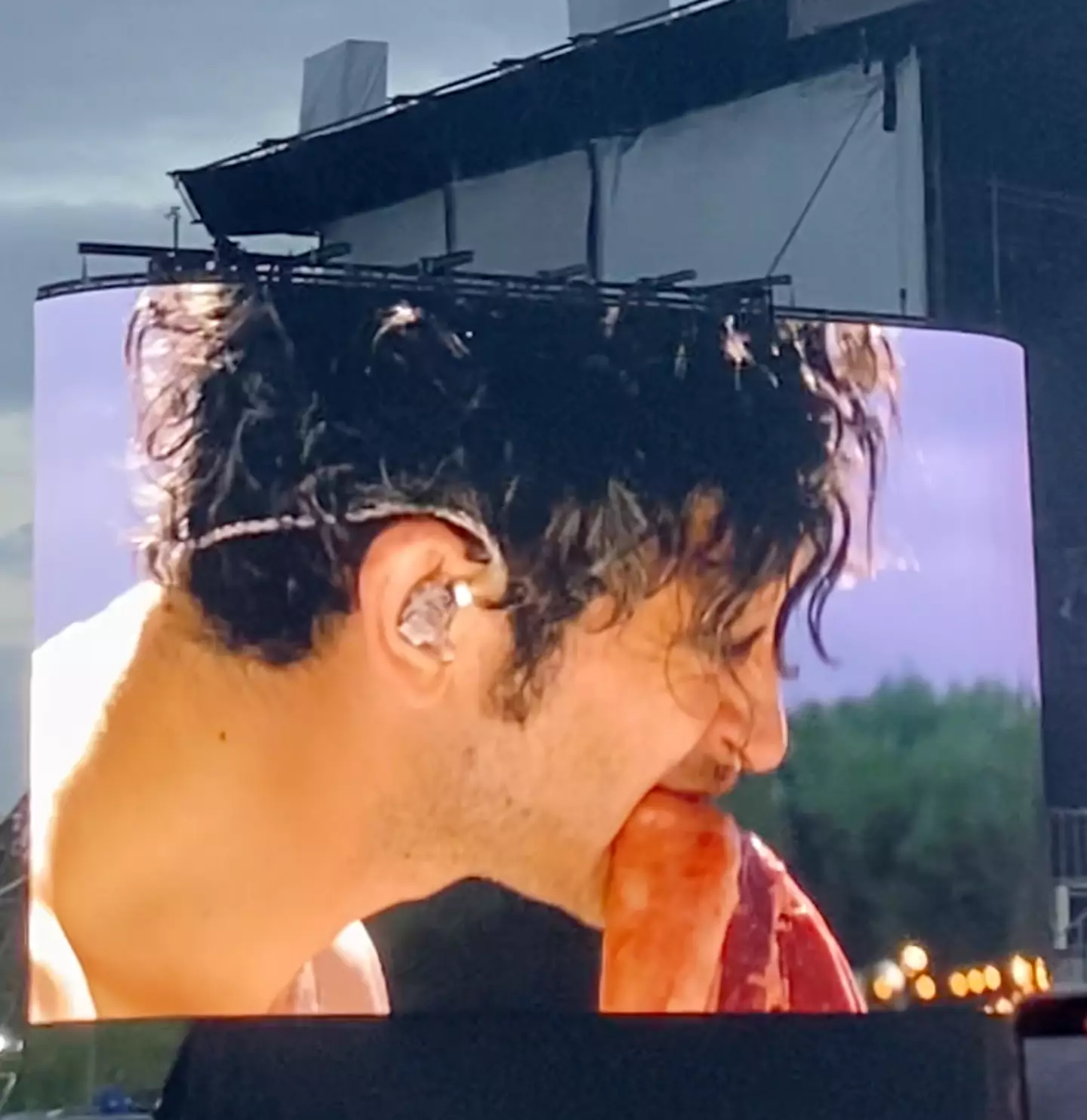 Matty Healy eating a raw steak on stage at Finsbury Park.