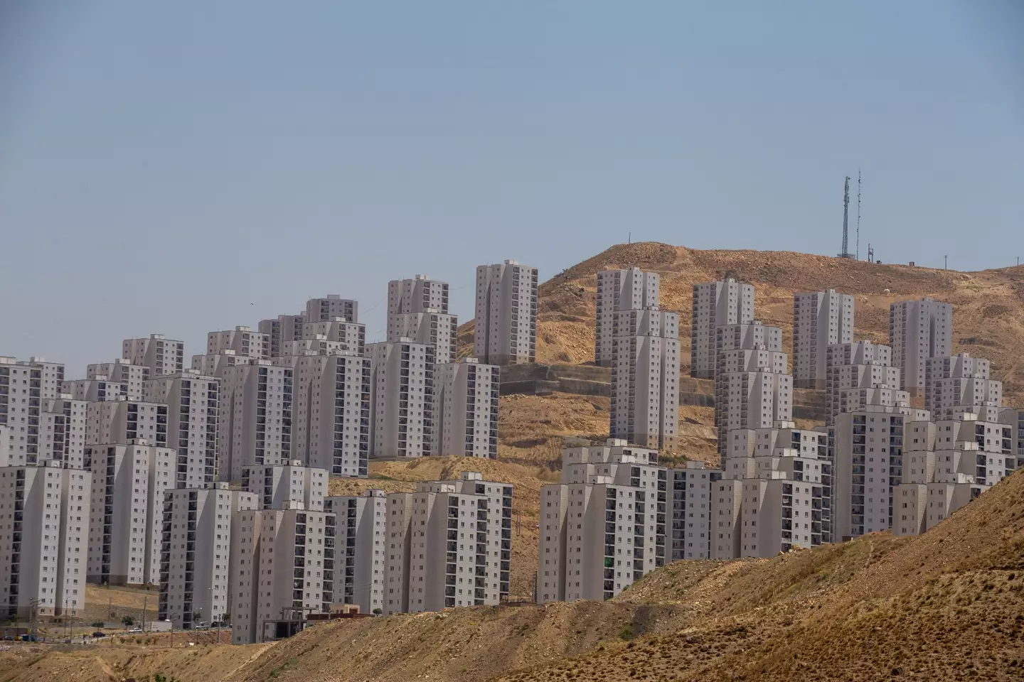 Thousands of people do live here, but thousands of homes sit empty and unfinished too. (HOSSEIN BERIS/Middle East Images/AFP via Getty Images)