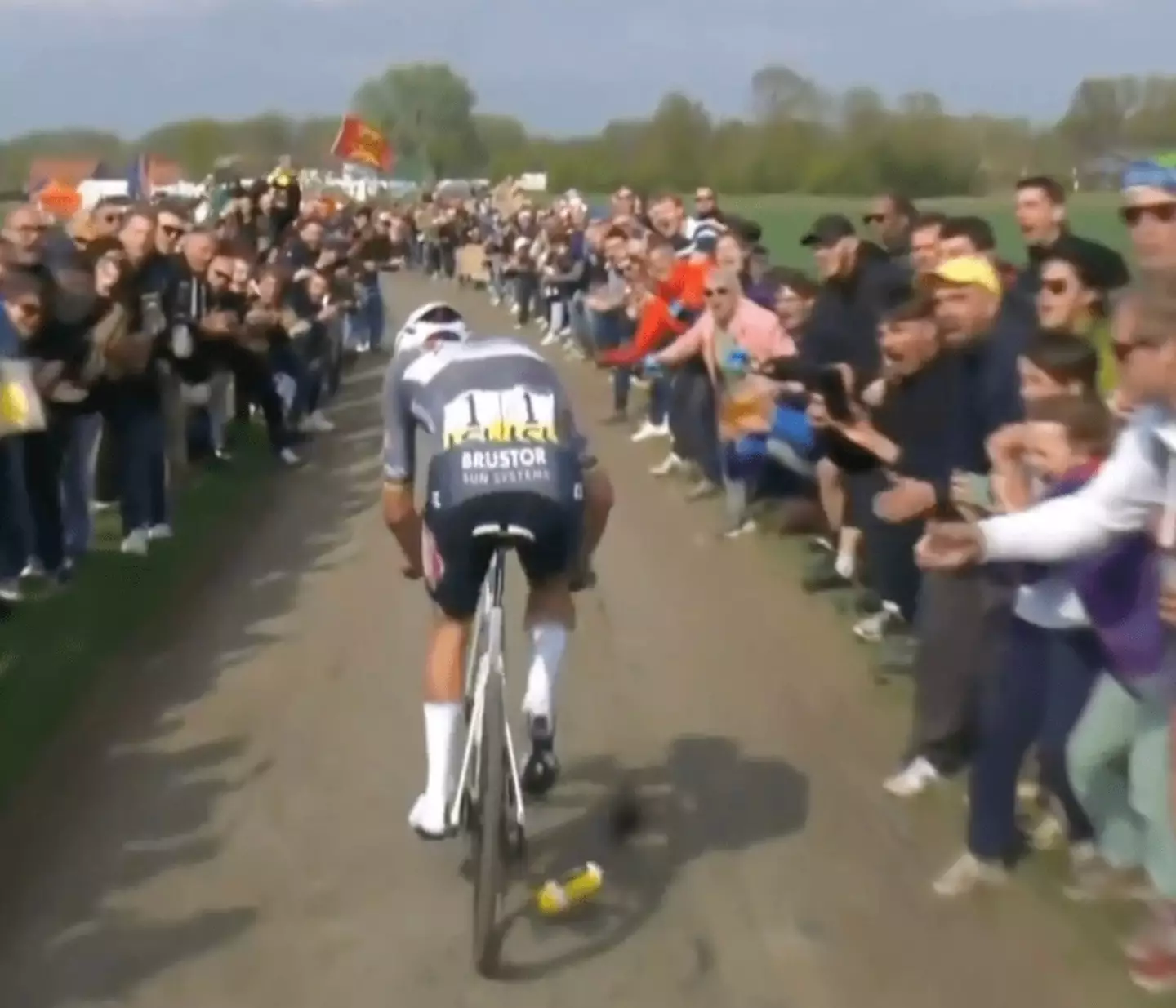 Mathieu van der Poel was seen flinching as the bottle struck him in the face (X/@NBCSCycling)